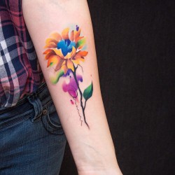 white flower tattoo on forearm