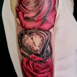 two red roses and clock shoulder tattoo