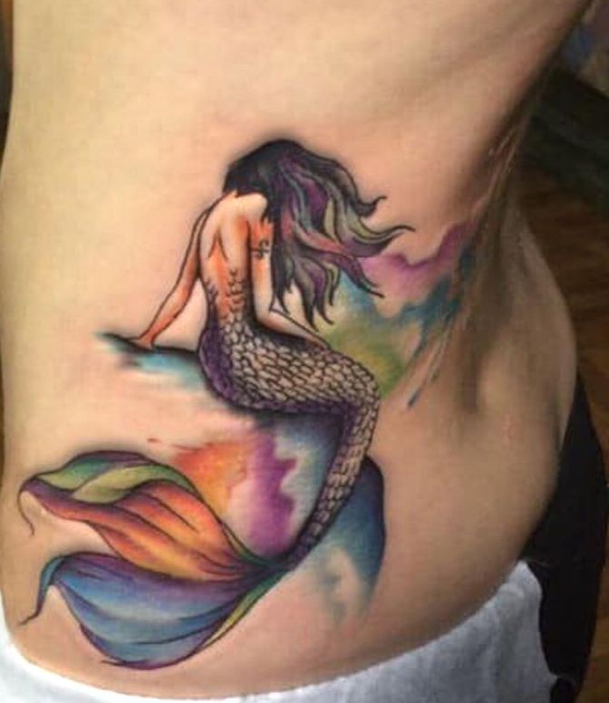 mermaid tattooed on her hip
