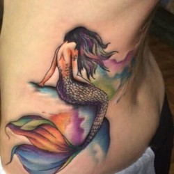 mermaid tattooed on her hip