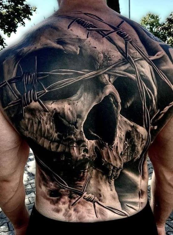 amazing and realistic skull on back tattoo