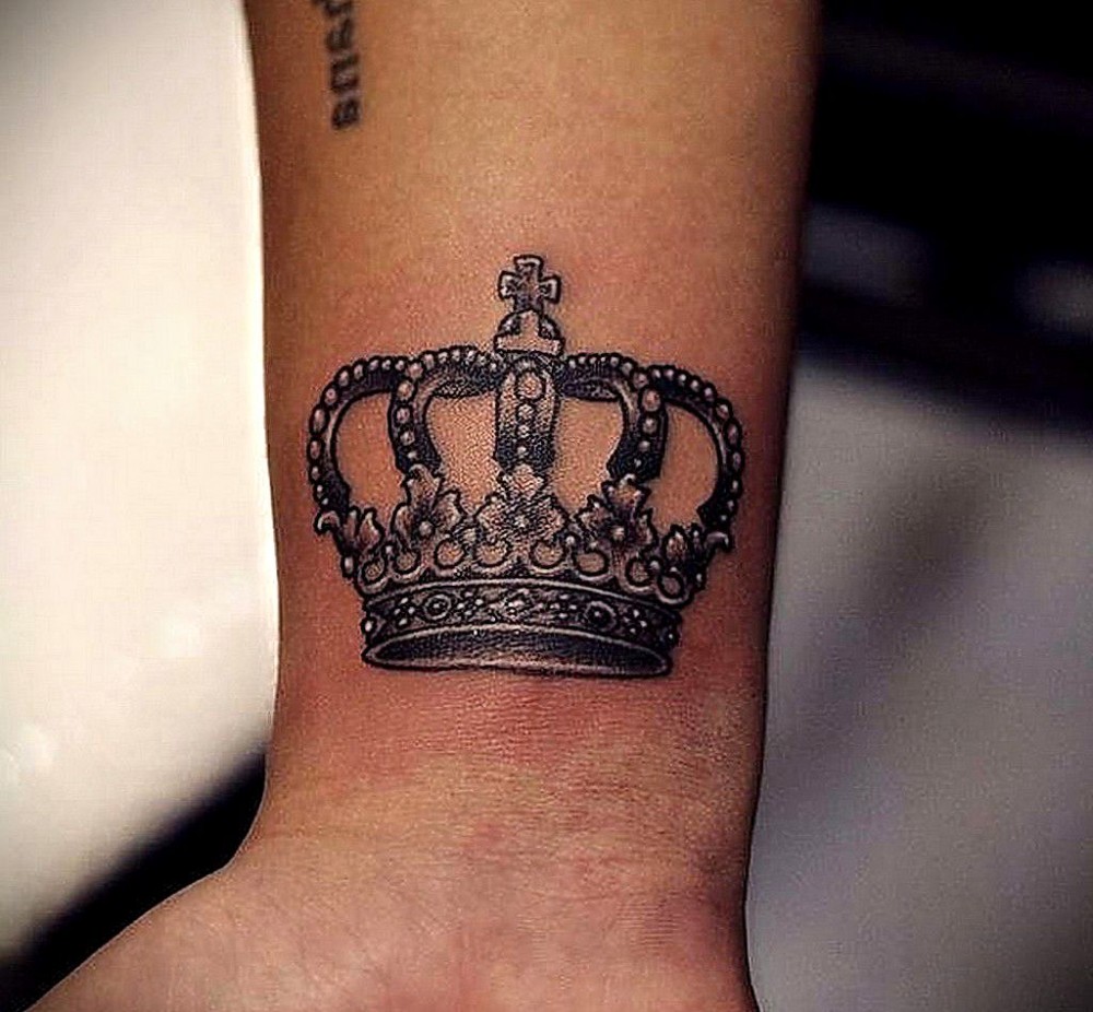 crown tattoo on the hand of a girl
