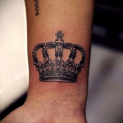 crown tattoo on the hand of a girl