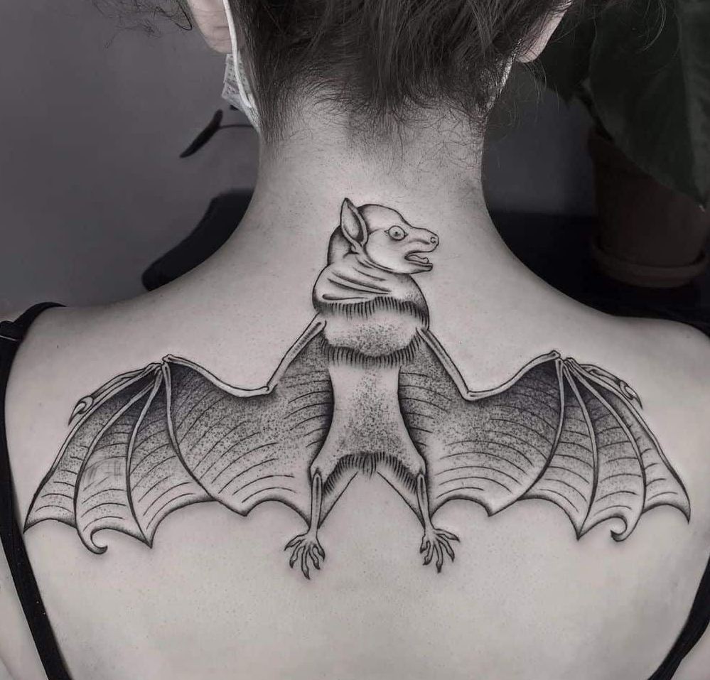 Upper back spread tattoo bat
