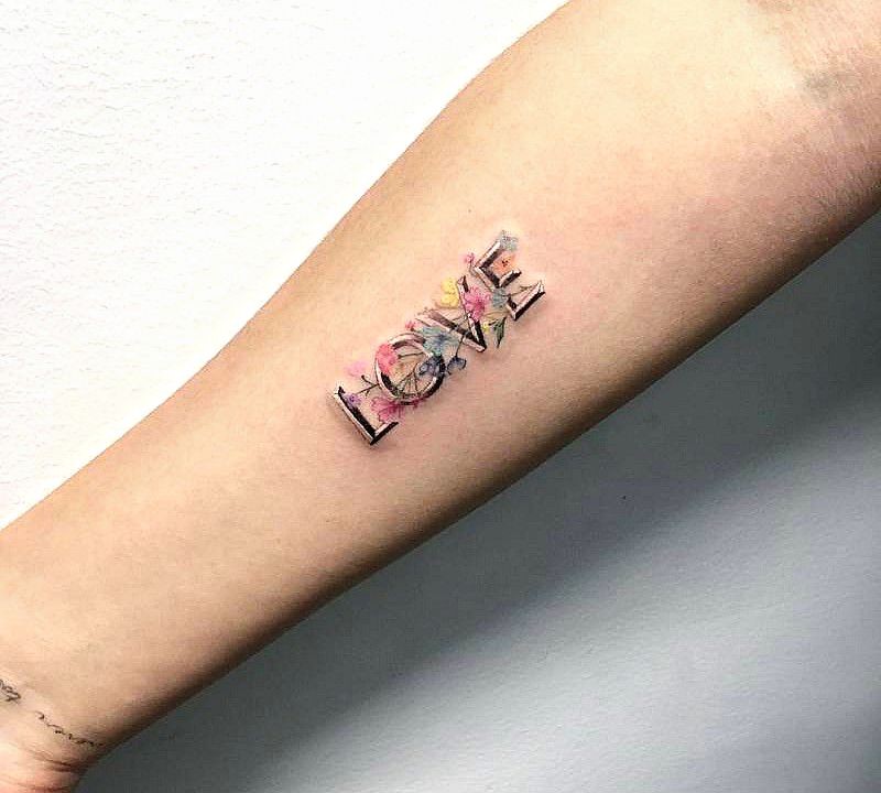 love tattoo on the right inner forearm