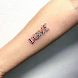 love tattoo on the right inner forearm