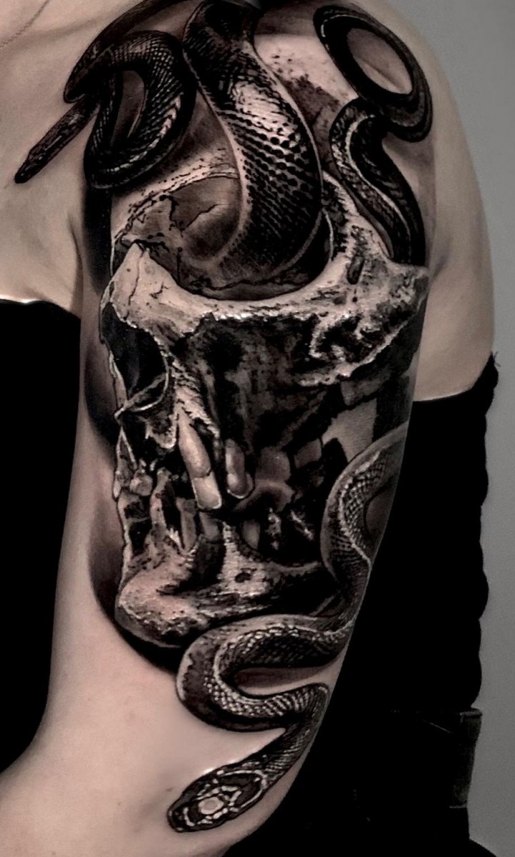 snake in the skull tattoo on the arm