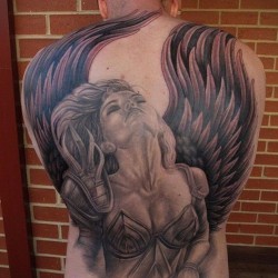 photo of a tattoo with an angel on the back
