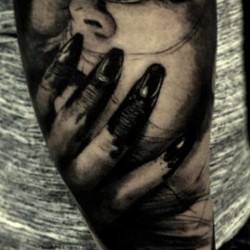 horror face in claw tattoo example